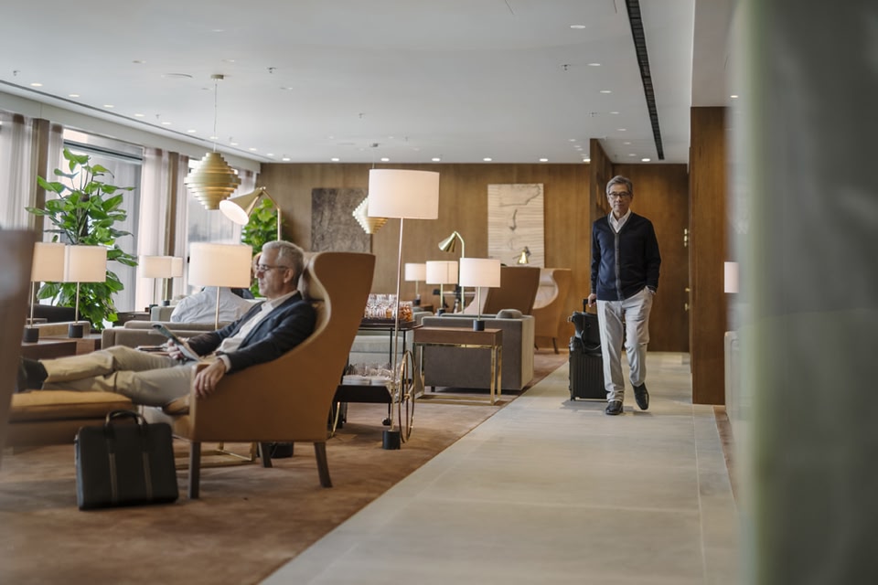 People sitting and walking in an airport lounge