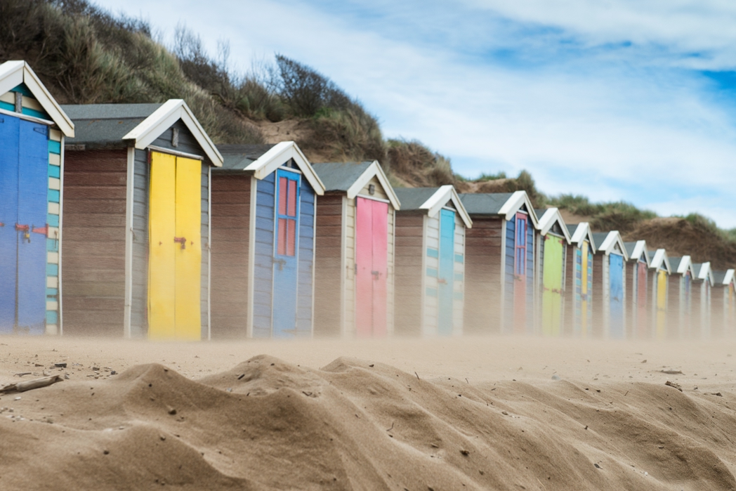 Colourful sheds in Saunton Sands, one of the best beaches in the UK