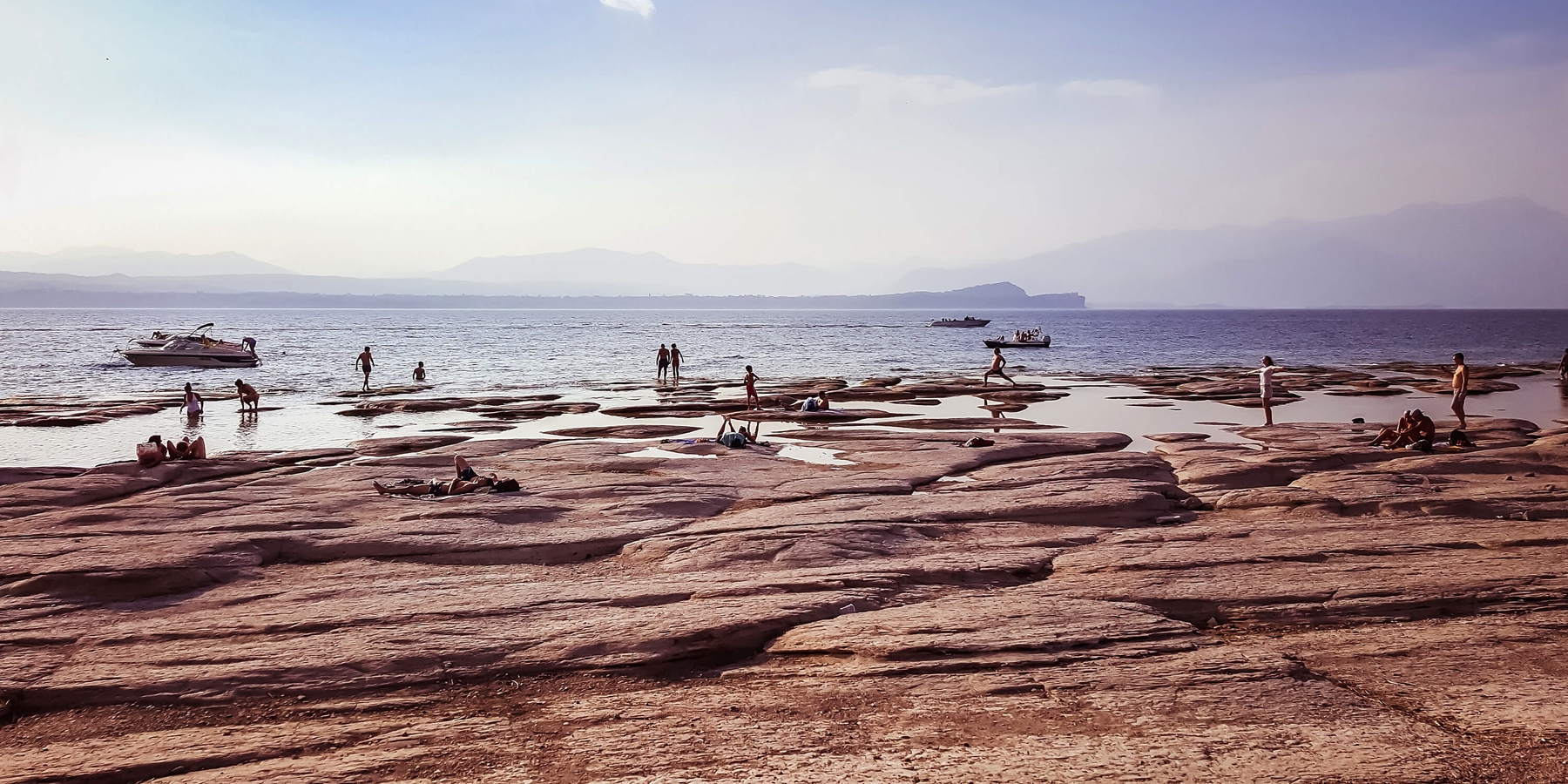 People on a rocky beach in Jamaica