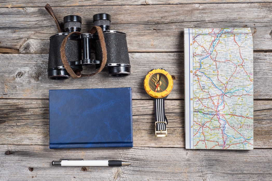 Binoculars, map, notebook and other travel essentials you must have in your hand luggage - one of the best packing tips for your holiday