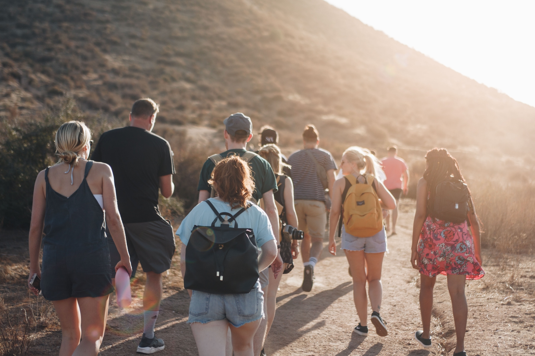 group of travellers walking up a mountain in Temecula, US.