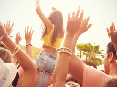 People dancing at an outdoor music festival.