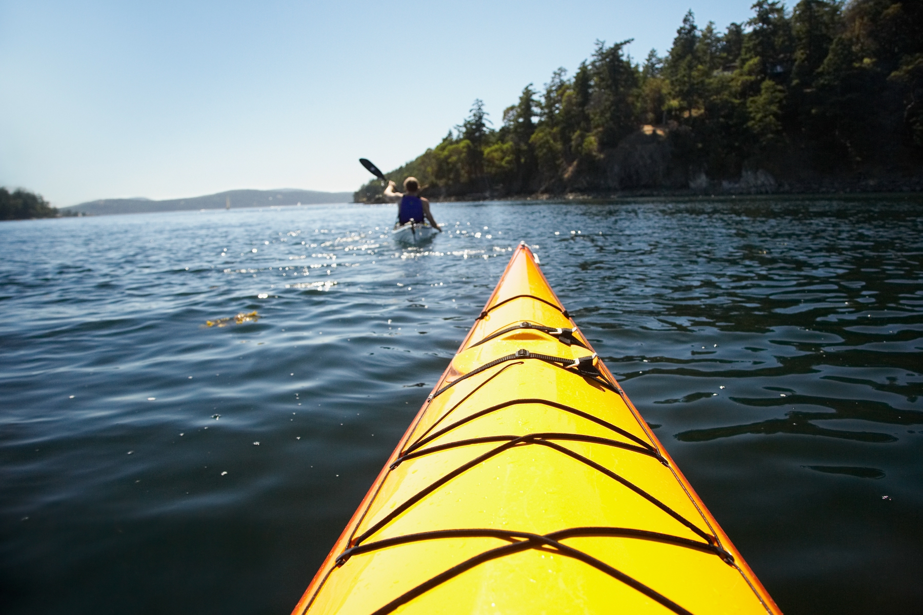 person kayaking in front of another one