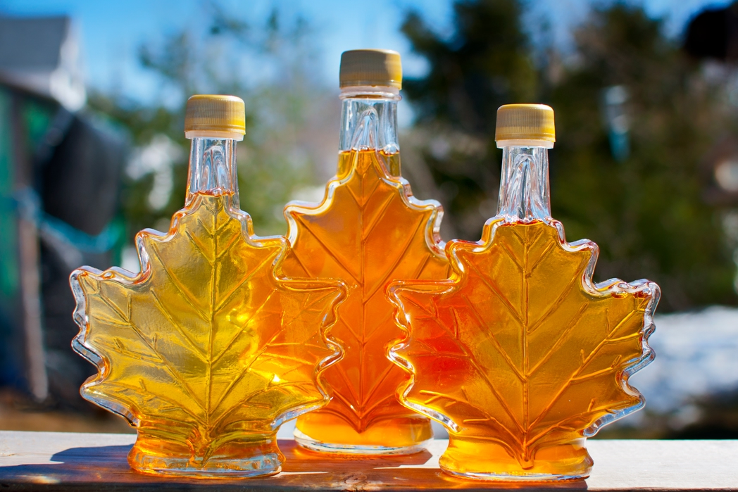 Three bottles of maple syrup made by a backyard hobbyist in Nova Scotia.