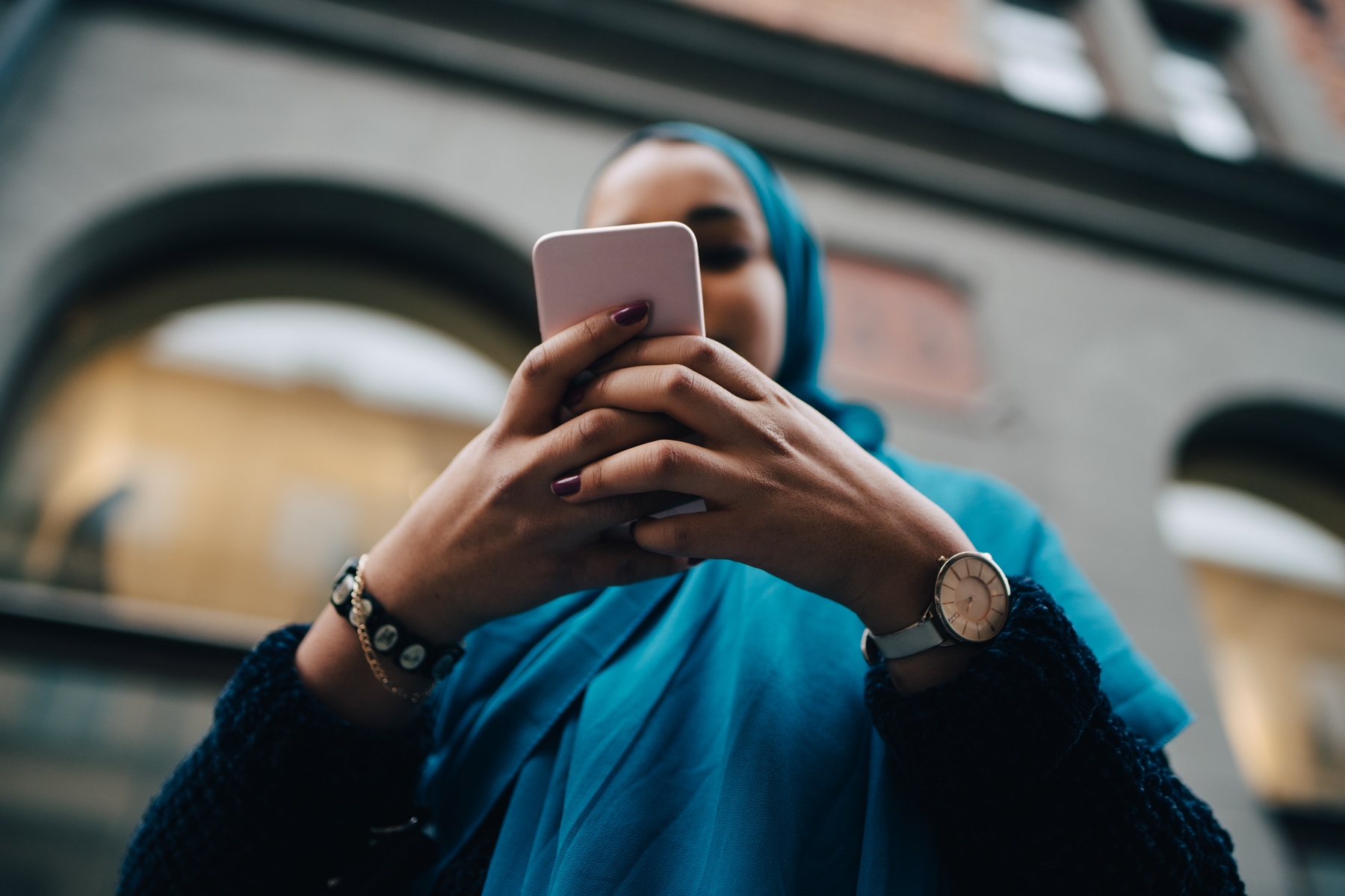A woman using her mobile telephone with a map