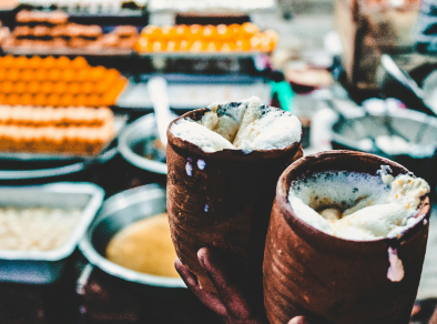 A delectable dessert bought from a Mumbai food market stall, held up close to the camera and tempting the viewer with its mouth-watering appearance.