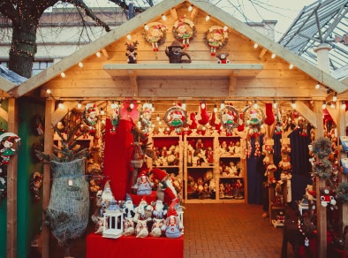 A picture of wooden Christmas hut selling Santa clause figurines