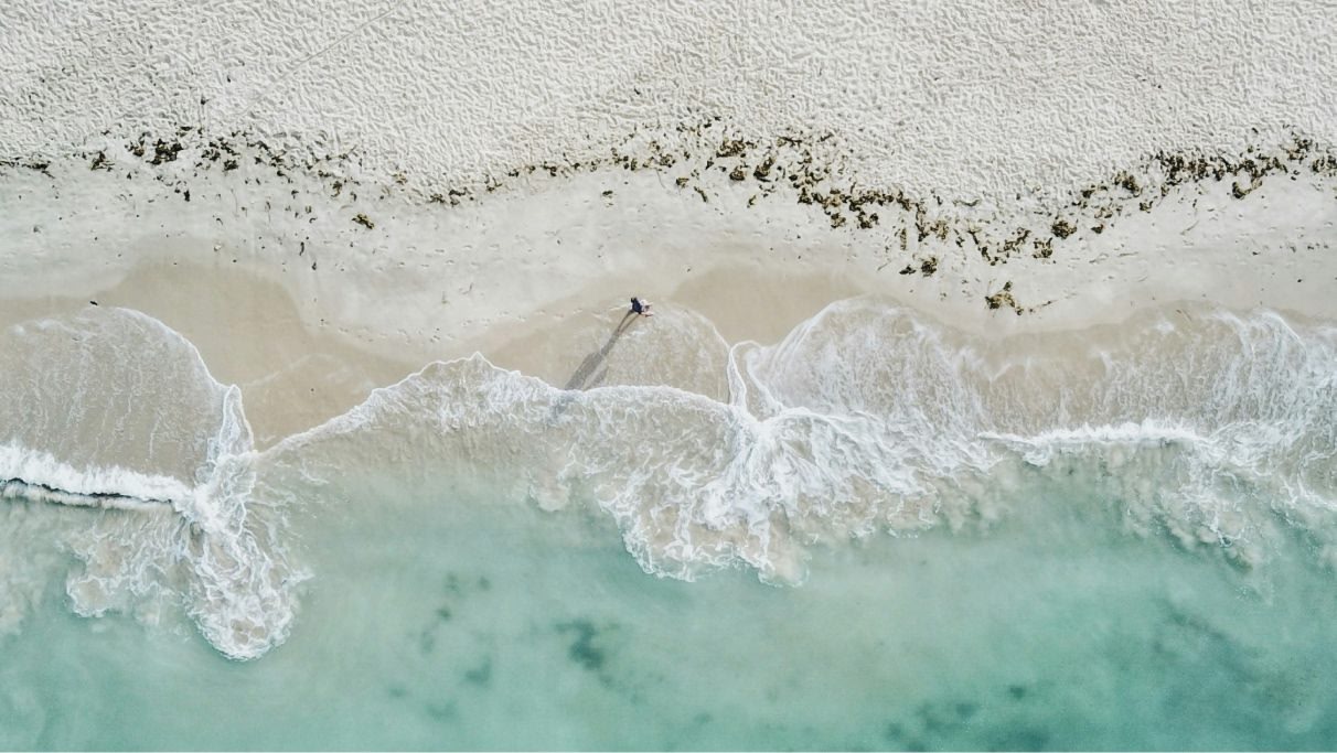 a panoramic photo of a person showing the coastline from the above