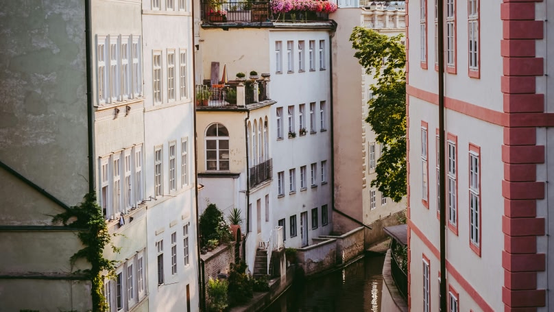 Street view of white buildings on a canal 