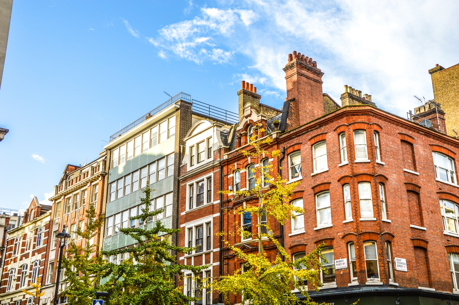 Traditional and modern buildings standing side by side on Market Place Great Titchfield Street, W1 London