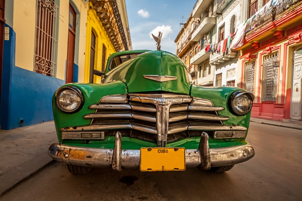 green classic American car parked on the streets of Havana, Cuba
