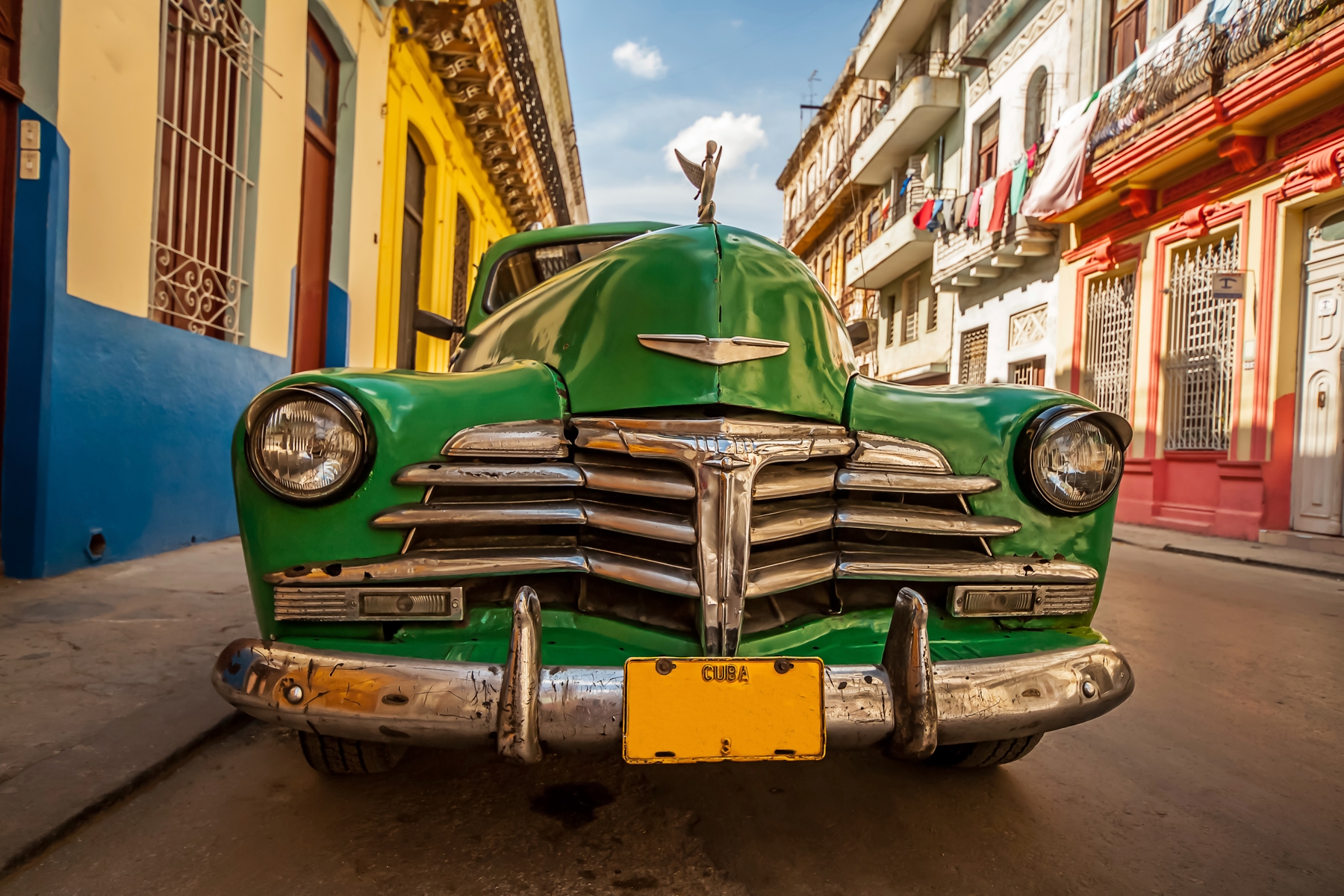 green classic American car parked on the streets of Havana, Cuba