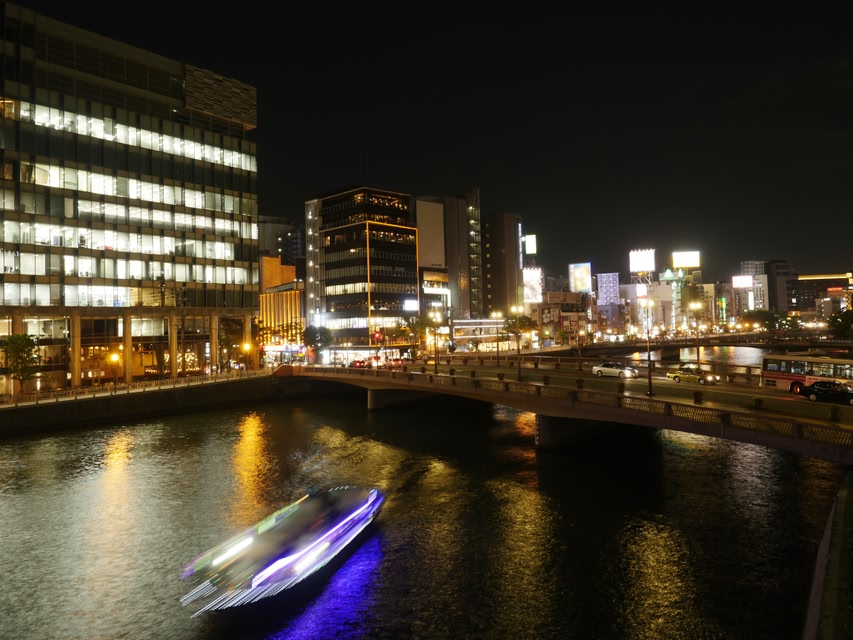 Night view of ‘Nakasu’ - downtown of Fukuoka city, and illuminated cruise ship.