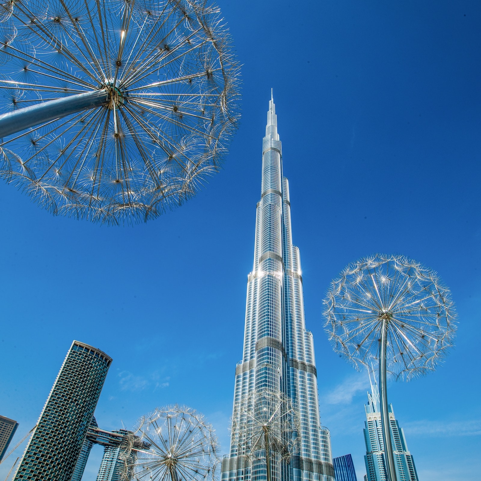 image of Burj Khalifa in Dubai looking up, blue skies during the day.