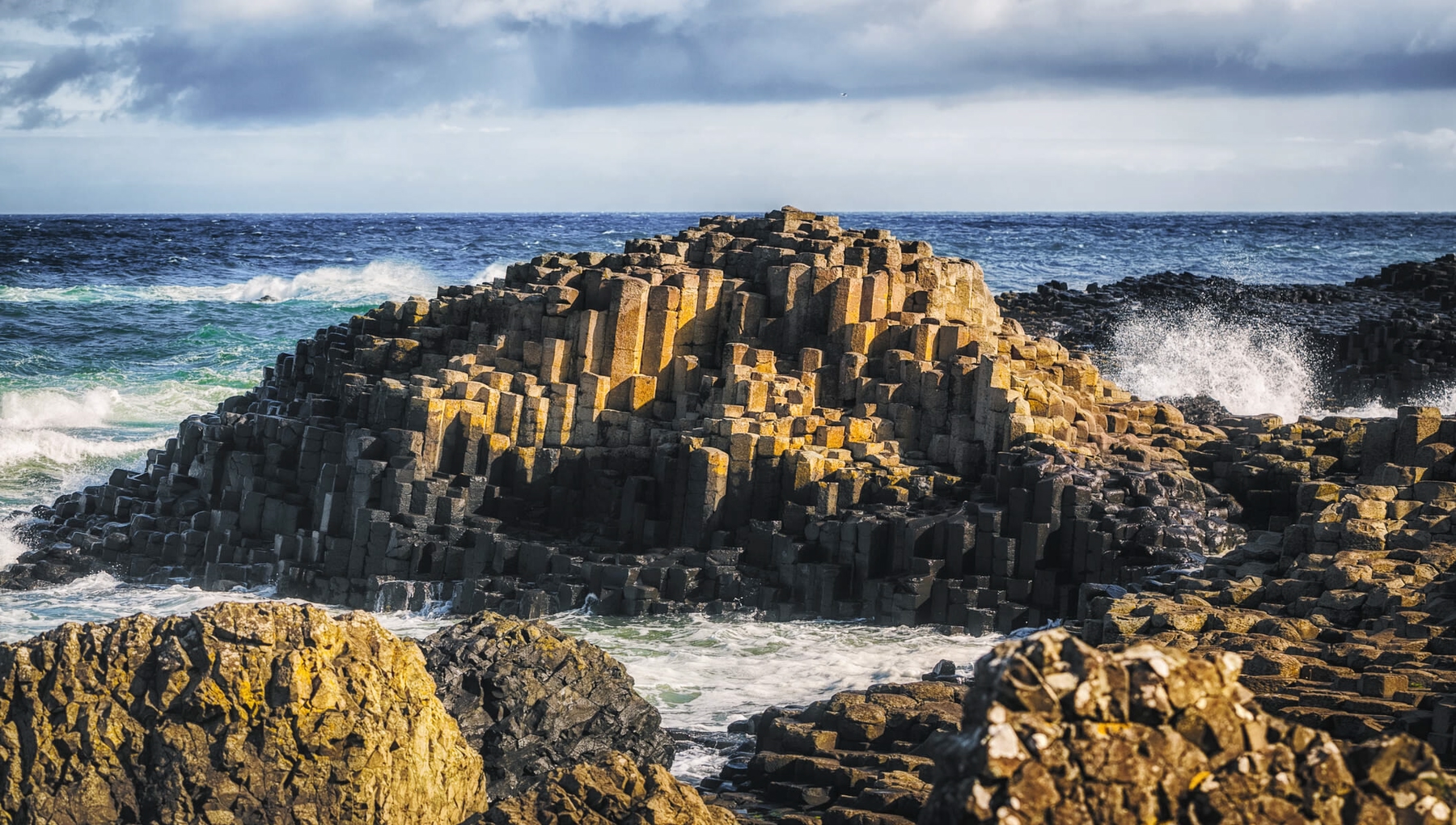 Dramatic waves crashing against the basalt columns of the Giant's Causeway.