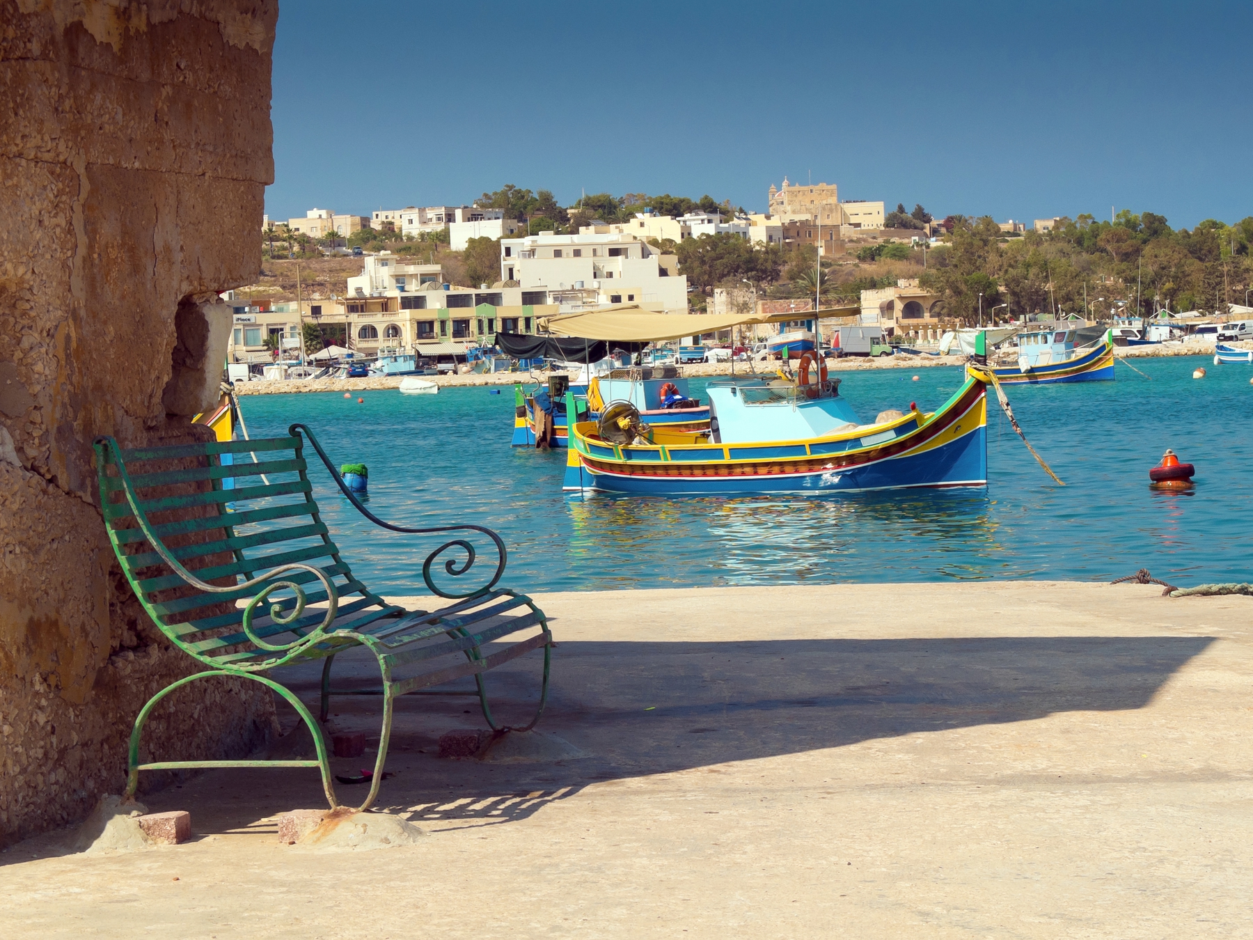 Colourful boat floating in a Malta harbour.