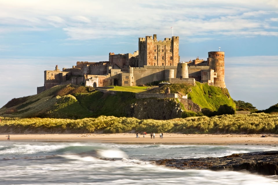 View of Bamburgh Castle with beach below, Northumberland, England.