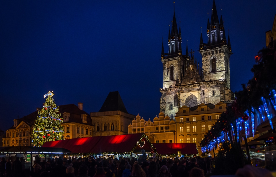 A night photo of a Prague Christmas Market in front of a lit up Cathedral. Best Christmas Cities: Prague / Skyscanner Canada
