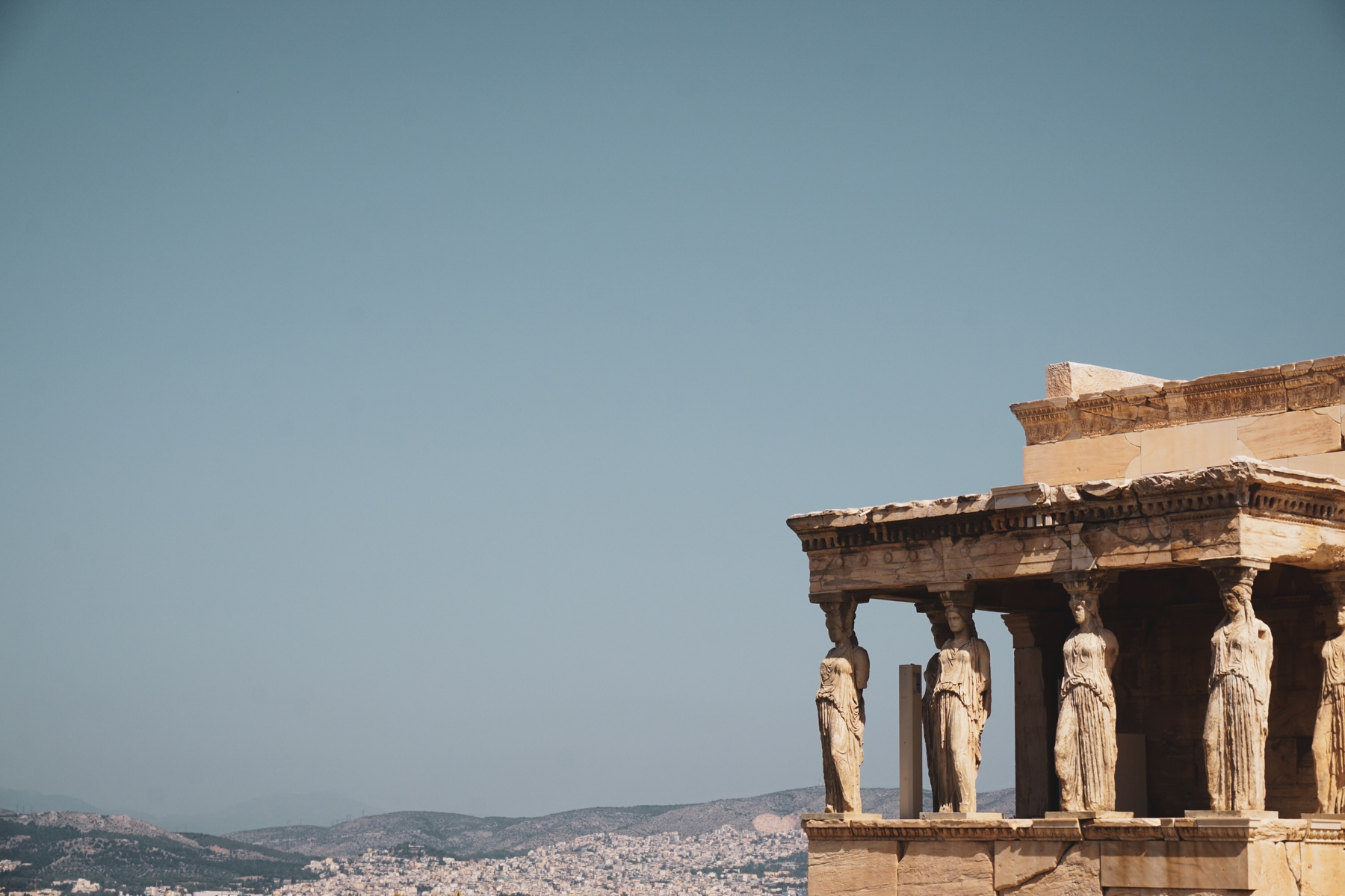 Caryatides at the Acropolis ruins in Athens. Outdoor attractions for your vacation to Greece