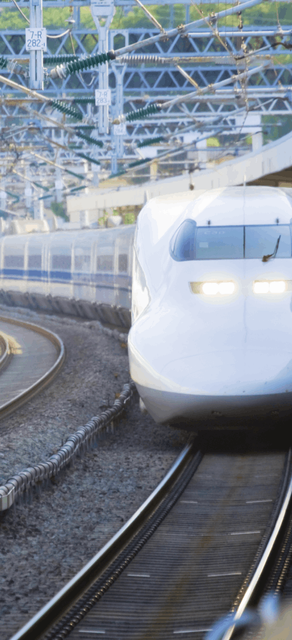 A head-on picture of a bullet train as its stopped at a station