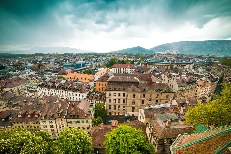 Geneva skyline with stormy skies and hills in the background.
