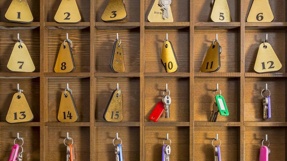 Hotel room keys hanging in individual cubby holes
