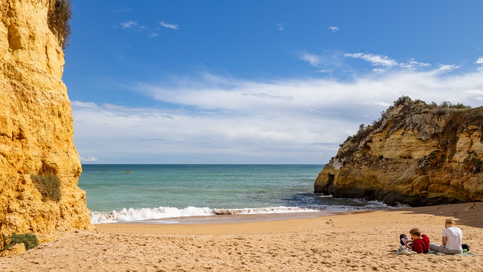beach bay and cliff during the day in Lagos, the Algarve region in Portugal. Blue sky and smooth clouds. 