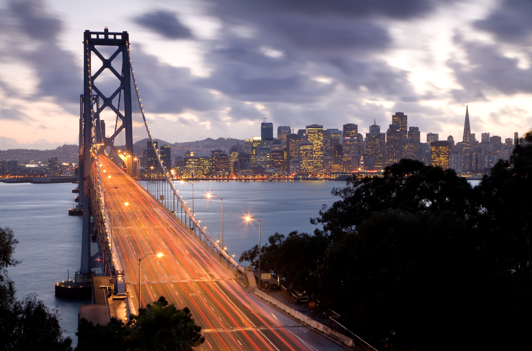 Long exposure shot of cars driving over the Bay Bridge into San Francisco