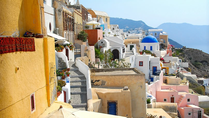 An image showing white and brown concrete buildings during daytime