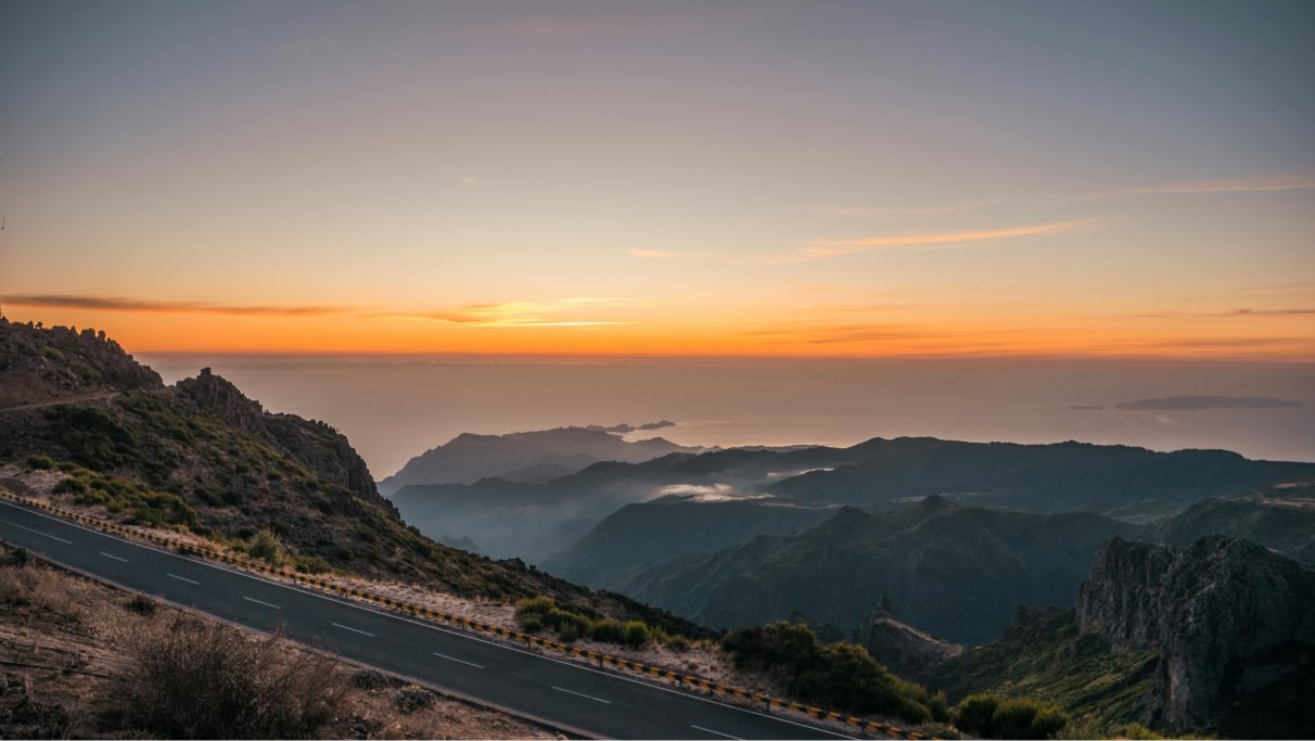 Portuguese country road with mountains bathed in the warm glow of a setting sun