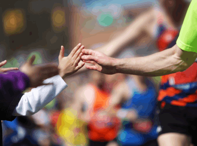 close up of a runner passing spectators at the Dublin Marathon