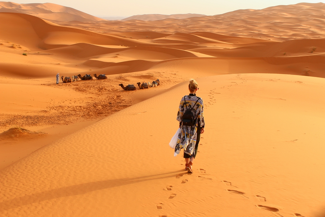 Woman walking through Sahara desert - long haul flights to Africa from Birmingham