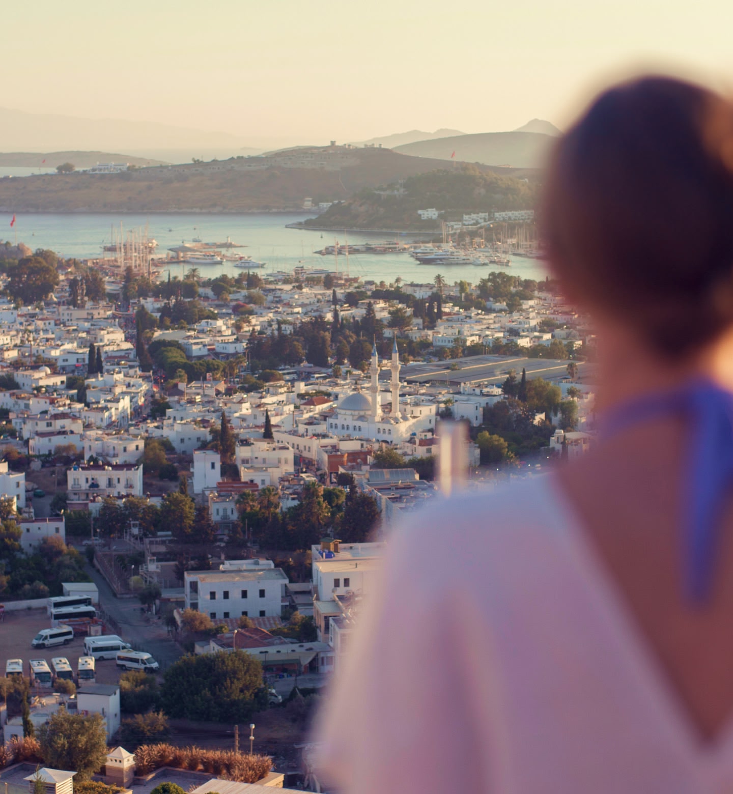 Women looks out over city scape at dusk in Bodrum Turkey