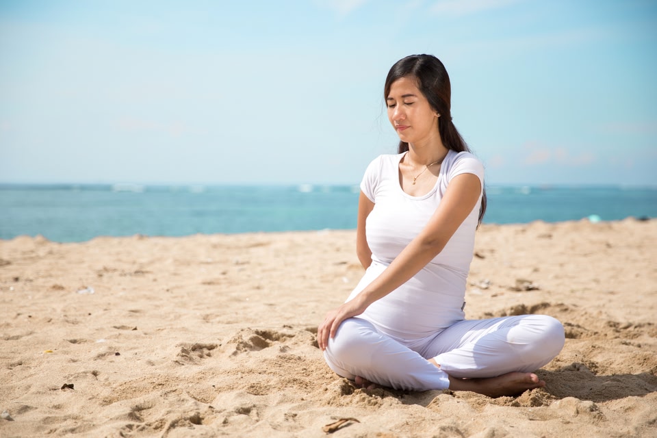 Pregnant woman on a beach