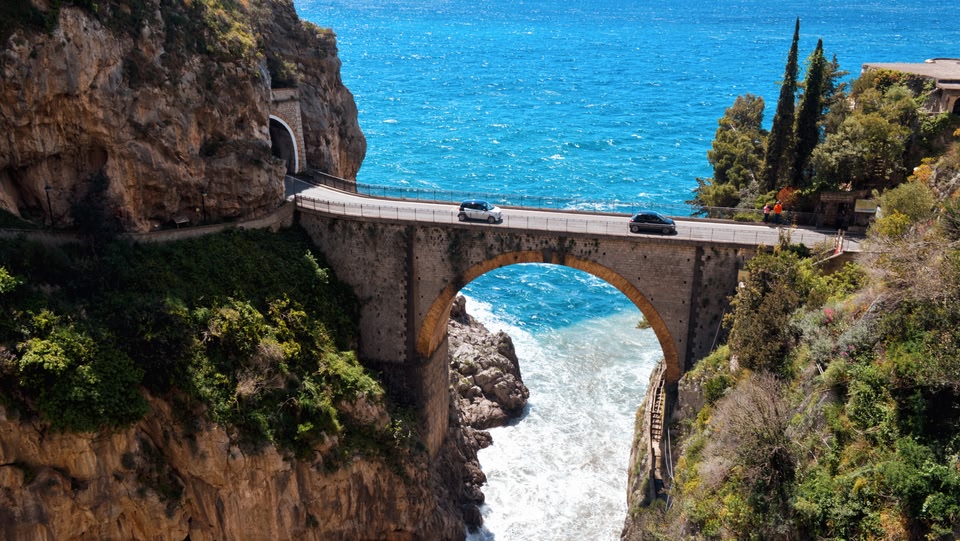 Cars driving over a sea bridge