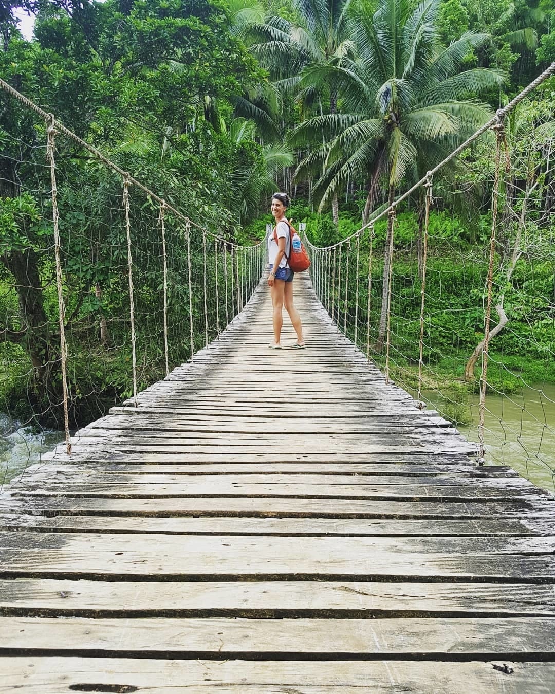 A female traveller on the hanging bridge in the Philippines