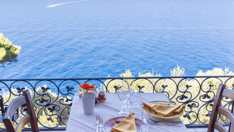 a table in front of the sea during daytime