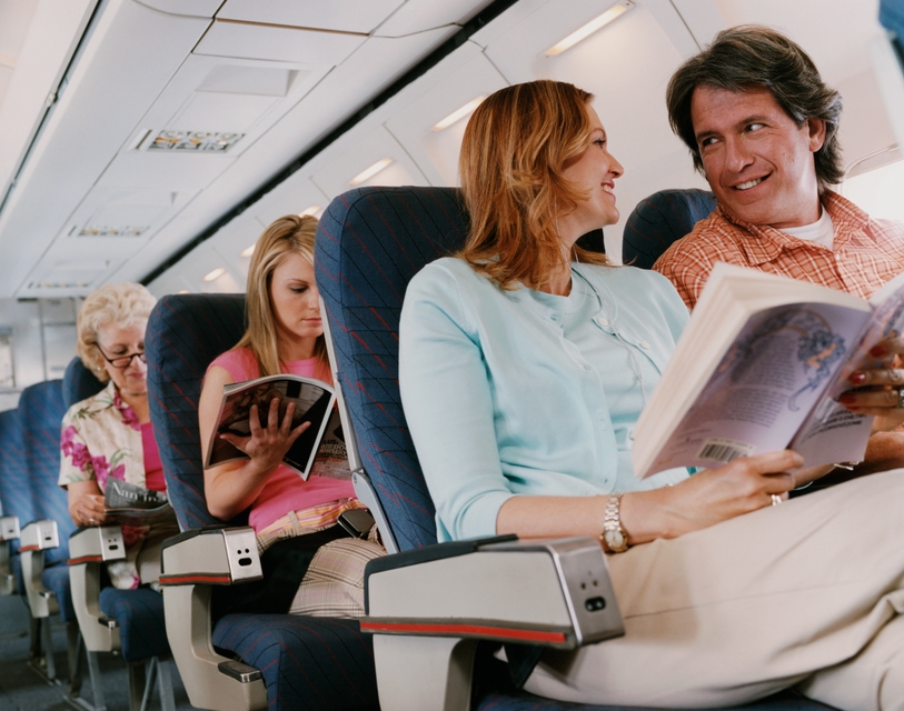 A couple talking to each other on a flight