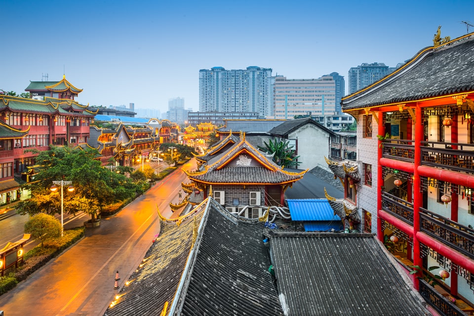 Street scene of Chengdu, showing traditional Chinese buildings in the foreground and modern skyscrapers in the background.