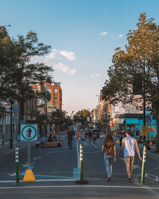 walkers on Mont-Royal Street in the summer in Montreal, late afternoon. Montreal is one of the top cities in Canada for travellers around the world.