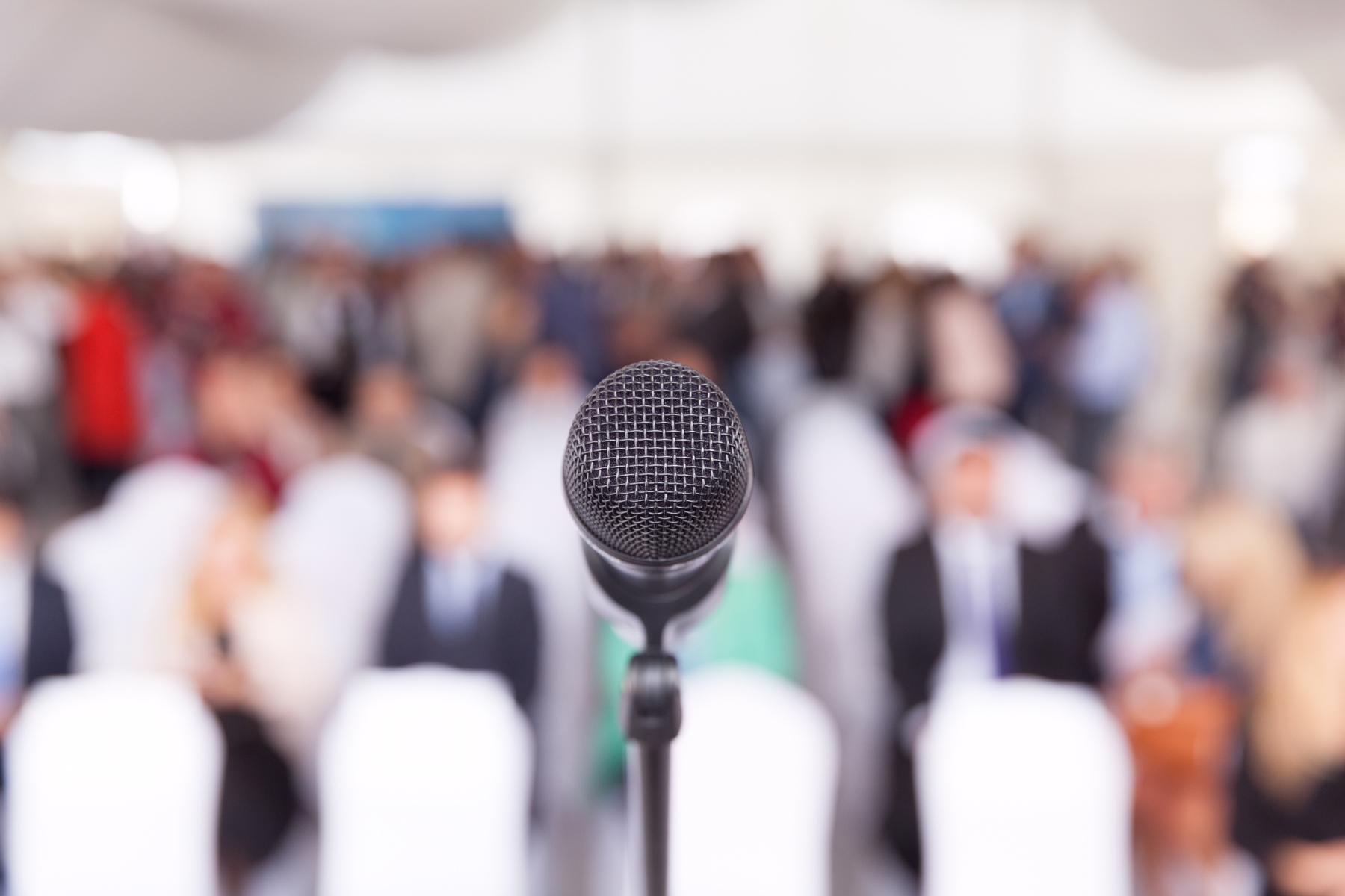 Record top culture podcast The Moth with mic in front of crowd