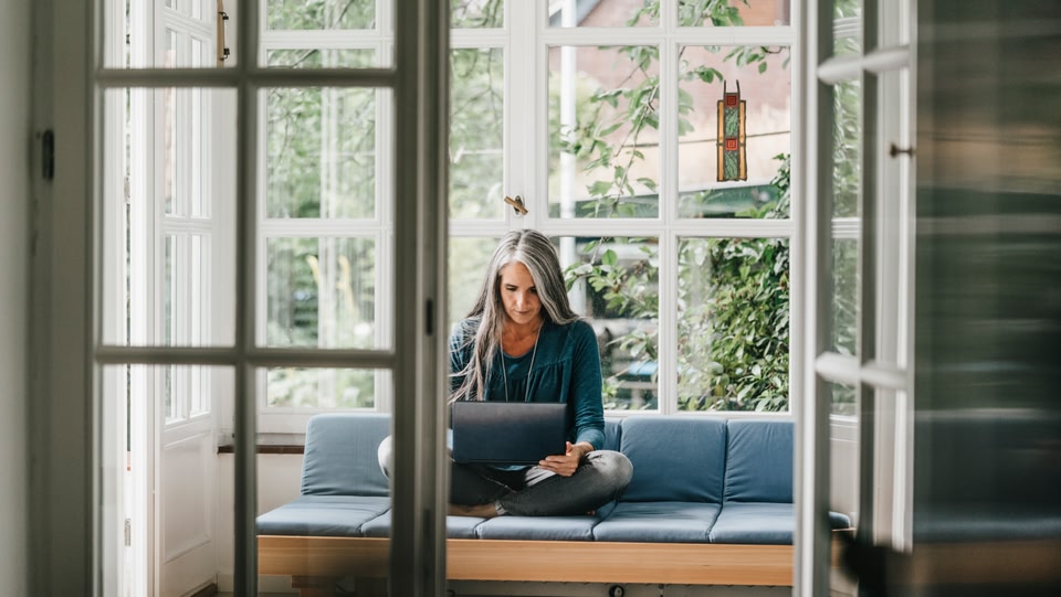 a women sat down on her laptop