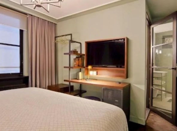 A hotel room with neutral tones at The Hoxton, Amsterdam.