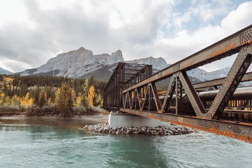 bridge in Canmore, Alberta Canada. Rocky Mountains in the background.