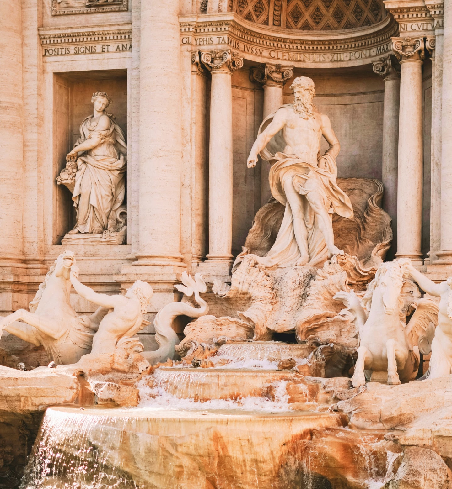 Baroque statues with cascading water at Rome’s iconic Trevi Fountain.