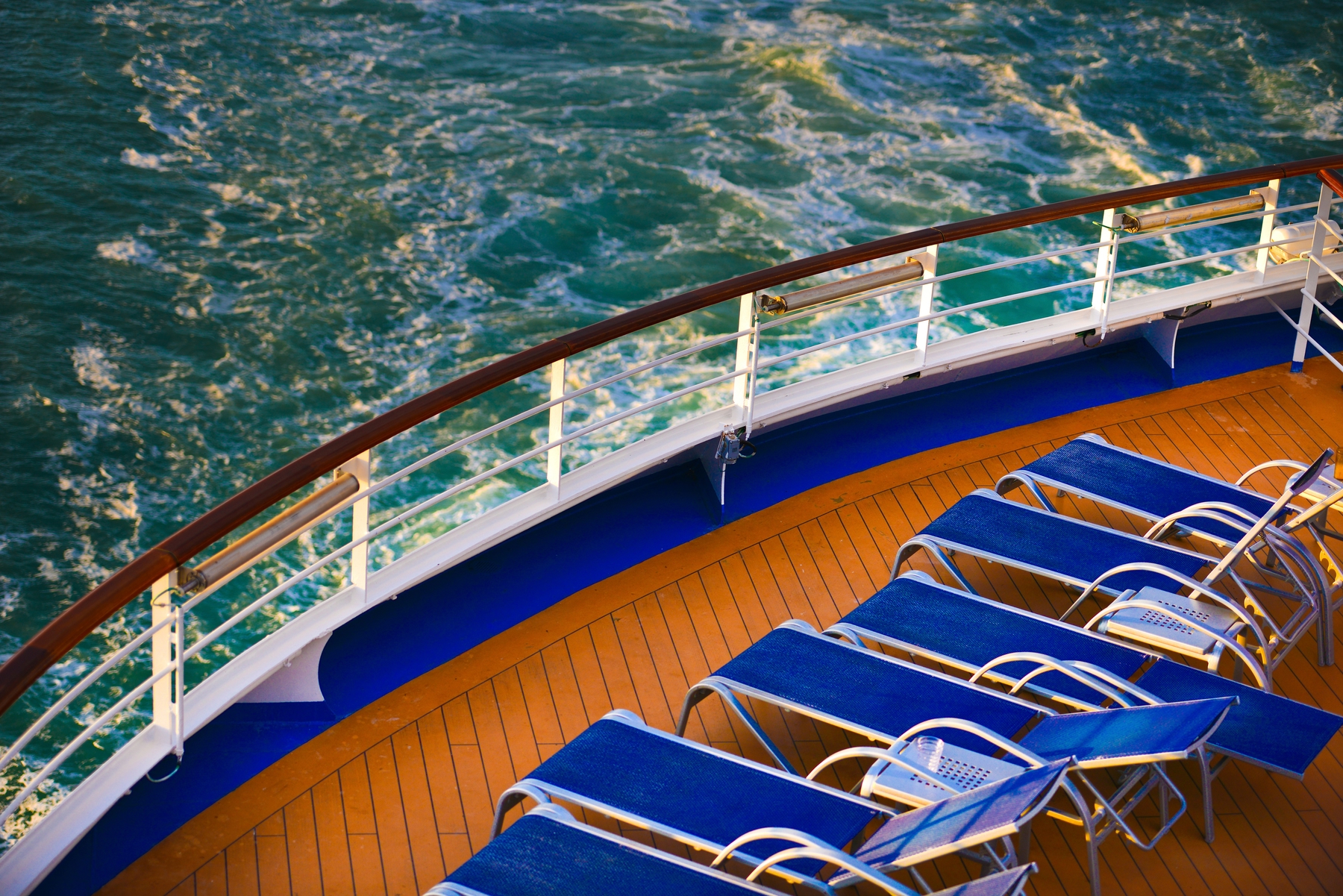 blue lounge chairs on a cruise ship