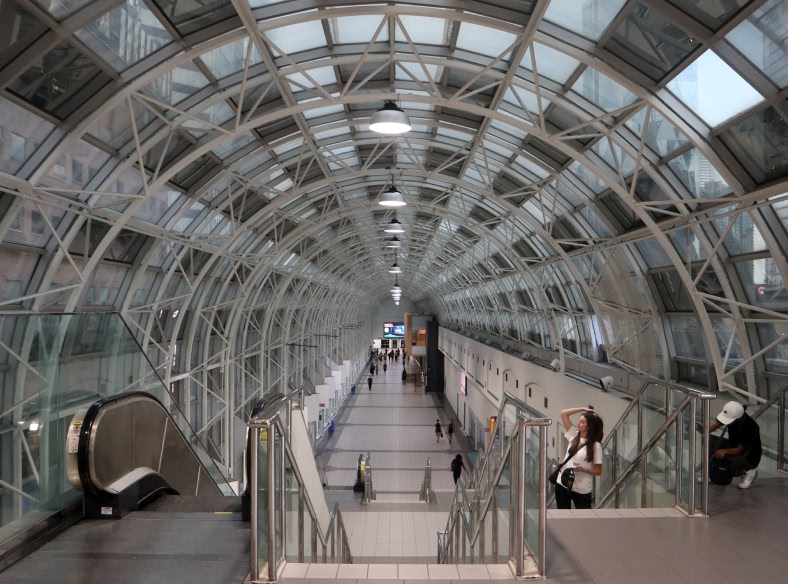 View of escalators and a central staircase in an airport terminal