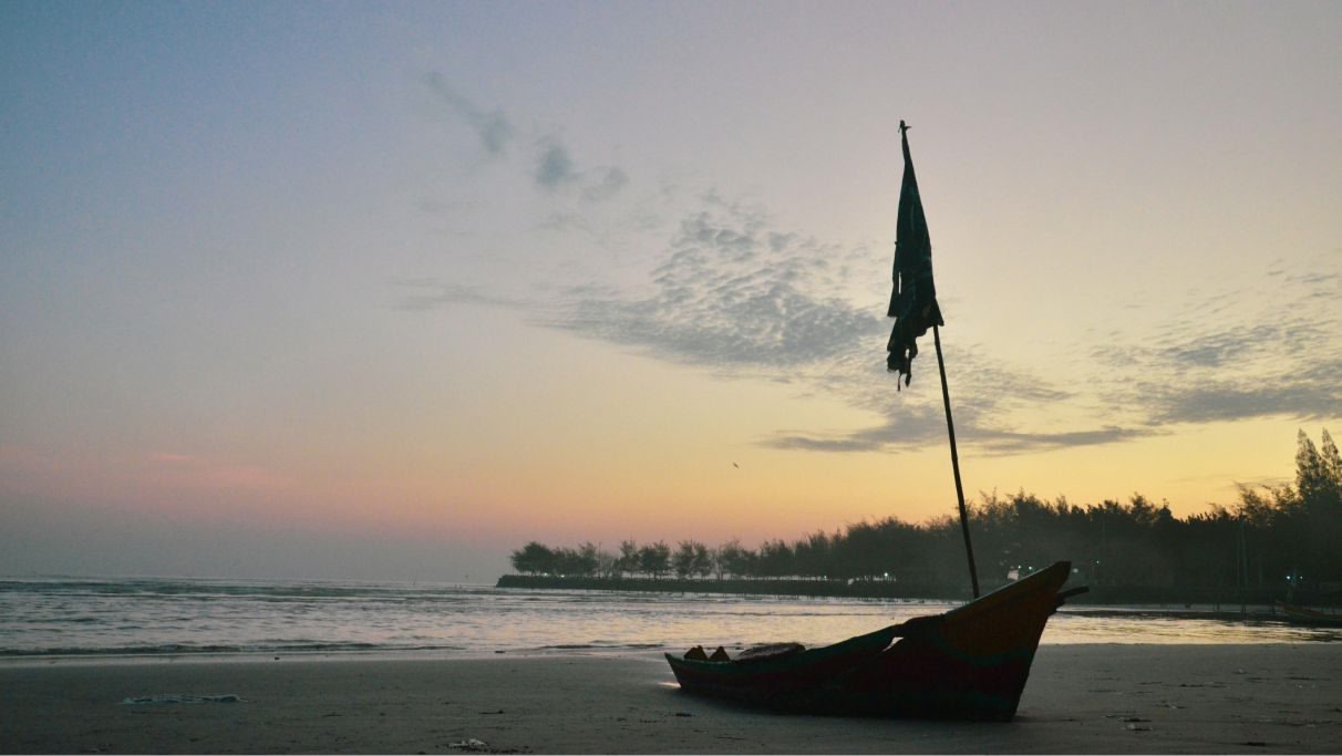 A boat by the seashore during evening time