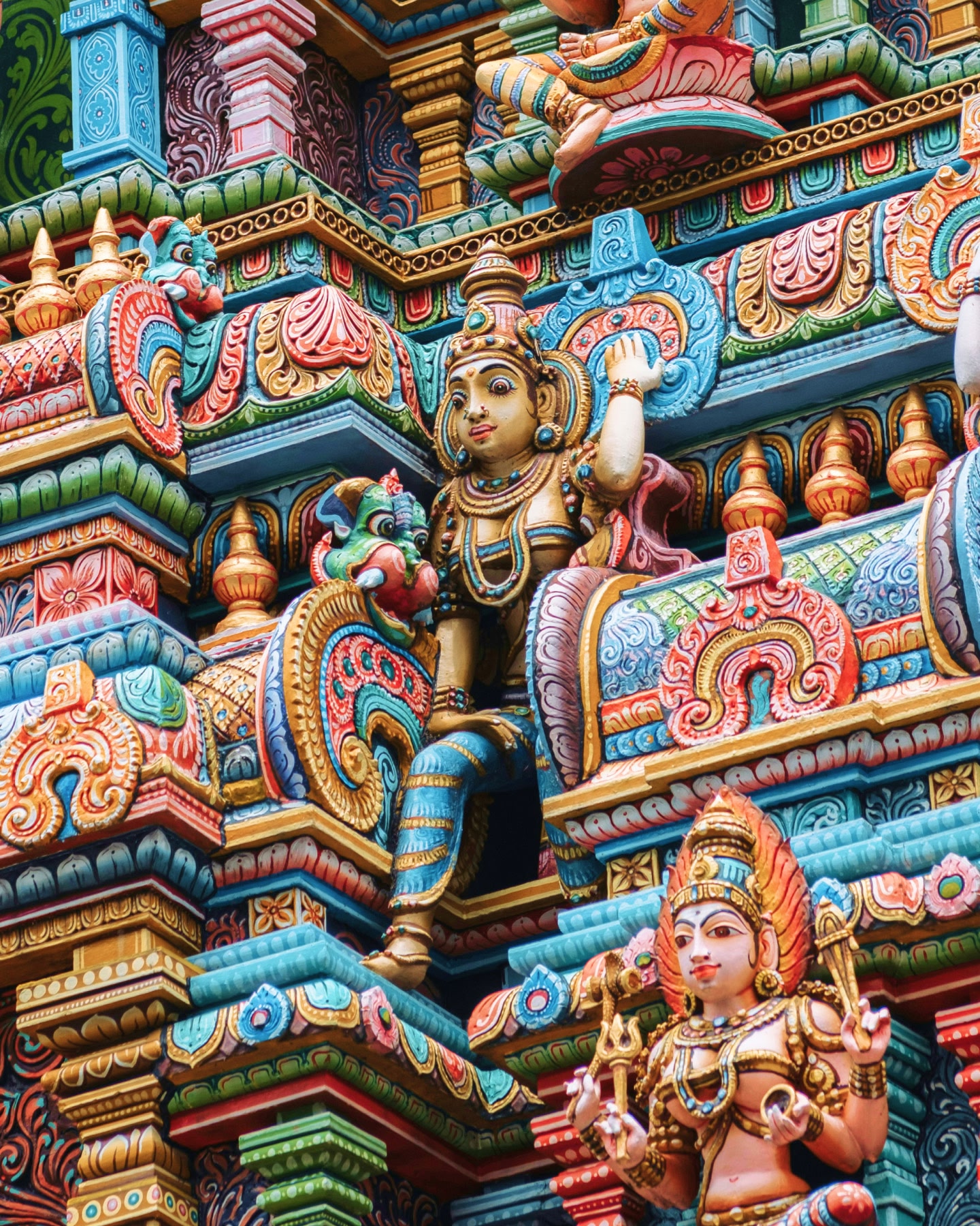Close-up of vibrant, colourful carvings on a Hindu temple façade in Chennai, India.