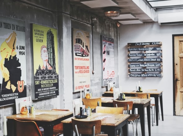 A cafe in Amsterdam with vintage prints on the wall.